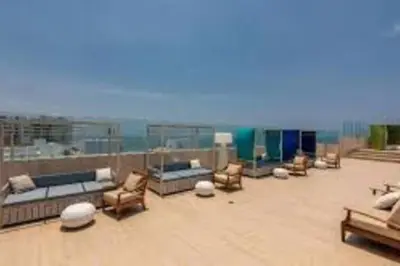 a patio with chairs and couches on a roof at Luxury apartment in Morros - Cartagena de Indias in Cartagena de Indias