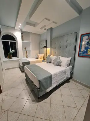 a large bedroom with two beds in a room at Casa Blanca del Mar in Santa Marta