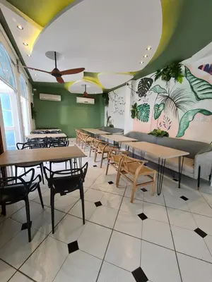 a row of tables and chairs in a restaurant at Casa Blanca del Mar in Santa Marta