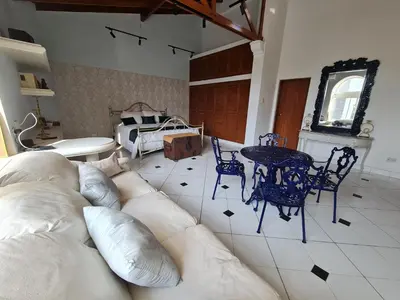 a living room with a couch and a table and chairs at Casa Blanca del Mar in Santa Marta