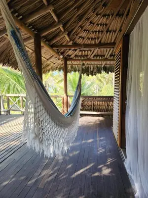 a hammock hanging from a roof on a porch at Cabana Ferrer in Notecebes