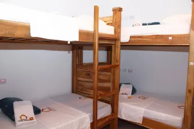 a room with two bunk beds with white sheets at Hostal Casa Torres Centro Historico - Adults Only in Cartagena de Indias