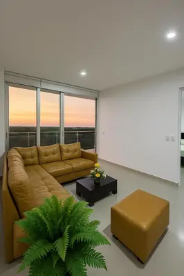 a living room with a brown couch and a table at Comodo Apartamento en morros epic! in Cartagena de Indias