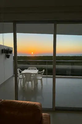 a living room with a table and chairs on a balcony at Comodo Apartamento en morros epic! in Cartagena de Indias