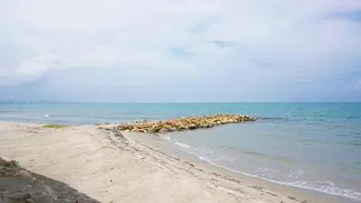 a group of rocks in the water on a beach at Cabaña Aire Viento Sol in Puerto Viejo
