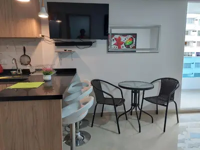 a kitchen with a table and chairs and a counter at Apartamento en cartagena in Cartagena de Indias