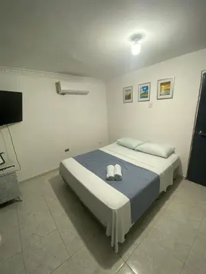 a bedroom with a bed with two towels on it at Habitación cerca al aeropuerto 2 in Cartagena de Indias