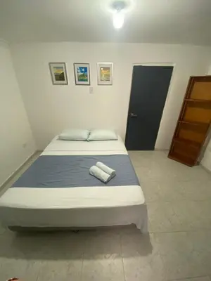 a bedroom with a bed with two towels on it at Habitación cerca al aeropuerto 2 in Cartagena de Indias