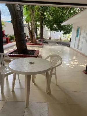 a white table and chairs sitting on a patio at Habitación cerca al aeropuerto 2 in Cartagena de Indias