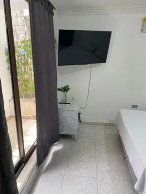 a room with a bed and a television on the wall at Habitación cerca al aeropuerto 2 in Cartagena de Indias