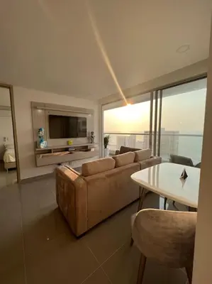 a living room with a couch and a table at Apartamento Moderno y lujoso con vista al mar Piso 1903 - cerca a ciudad amurallada in Cartagena de Indias