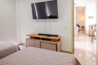 a bedroom with a bed and a flat screen tv at Apartamento Moderno y lujoso con vista al mar Piso 1903 - cerca a ciudad amurallada in Cartagena de Indias