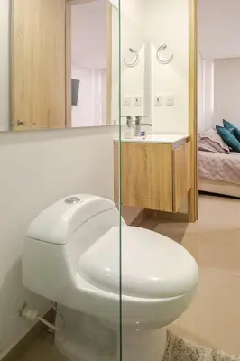 a bathroom with a toilet and a sink at Apartamento Moderno y lujoso con vista al mar Piso 1903 - cerca a ciudad amurallada in Cartagena de Indias