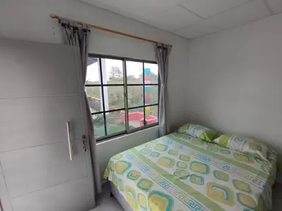 a small bedroom with a bed and a window at Cabaña Isabella in San Bernardo del Viento