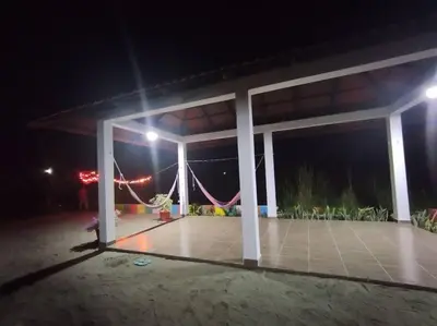 a covered patio at night with lights at Cabaña Isabella in San Bernardo del Viento