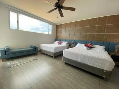 a bedroom with two beds and a ceiling fan at Ctgna 10 personas 3 habitaciones Playa Américas Morros in Cartagena de Indias