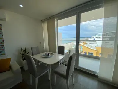 a dining room with a table and chairs and a large window at Ctgna 10 personas 3 habitaciones Playa Américas Morros in Cartagena de Indias