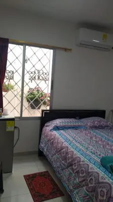 a bedroom with a bed and a large window at Casa Bellavista Barranquilla in Barranquilla