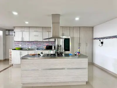 a kitchen with a large island in a room at HELENE HOUSE in Sincelejo