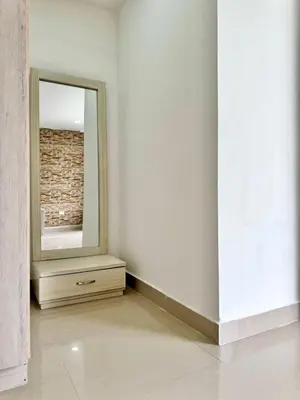 a white room with a mirror and a dresser at HELENE HOUSE in Sincelejo