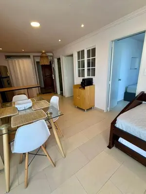 a bedroom with a bed and a table and chairs at El Laguito, Edificio El Conquistador in Cartagena de Indias