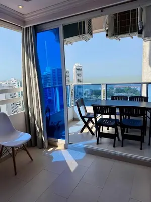 a dining room with a table and chairs on a balcony at El Laguito, Edificio El Conquistador in Cartagena de Indias