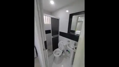 a bathroom with a toilet and two sinks and a mirror at Bm-16 room near the sea with air conditioning and WIFI in Cartagena de Indias