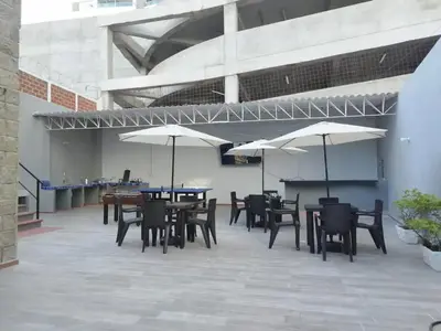 a patio with tables and chairs and umbrellas at Cozy room Bm-10 near the sea with air conditioning and WIFI in Cartagena de Indias