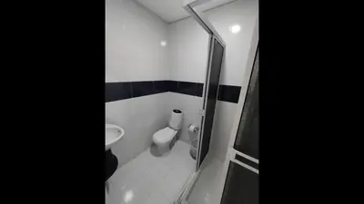 a small bathroom with a toilet and a shower at Bm-2 room near the sea with air conditioning and WIFI in Cartagena de Indias