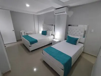 a bedroom with two beds with blue and white at Bm-17 Charming Cartagena Lodge with Shared Pool Terrace in Cartagena de Indias
