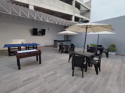a room with ping pong tables and umbrellas at Bm-5 room near the sea with air conditioning and WIFI in Cartagena de Indias