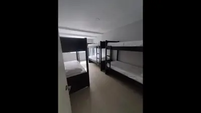 a room with three bunk beds and a hallway at Bm-15 room near the sea with air conditioning and WIFI in Cartagena de Indias
