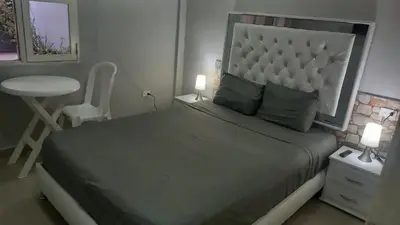 a bedroom with a bed and a table and a chair at Bm-6 room near the sea with air conditioning and WIFI in Cartagena de Indias