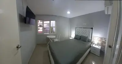 a small bedroom with a bed and a window at Bm-6 room near the sea with air conditioning and WIFI in Cartagena de Indias