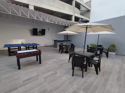 a room with ping pong tables and umbrellas at Bm-7 room near the sea with air conditioning and WIFI in Cartagena de Indias