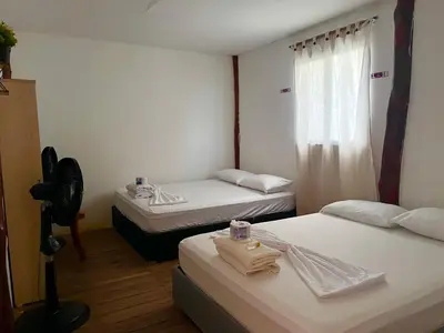 a room with two beds and a window at Roma beach in Cartagena de Indias