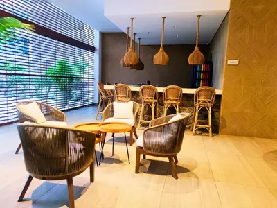 a dining room with chairs and a table and a counter at Playa Dormida 2. Hermoso apartamento frente al mar in Santa Marta